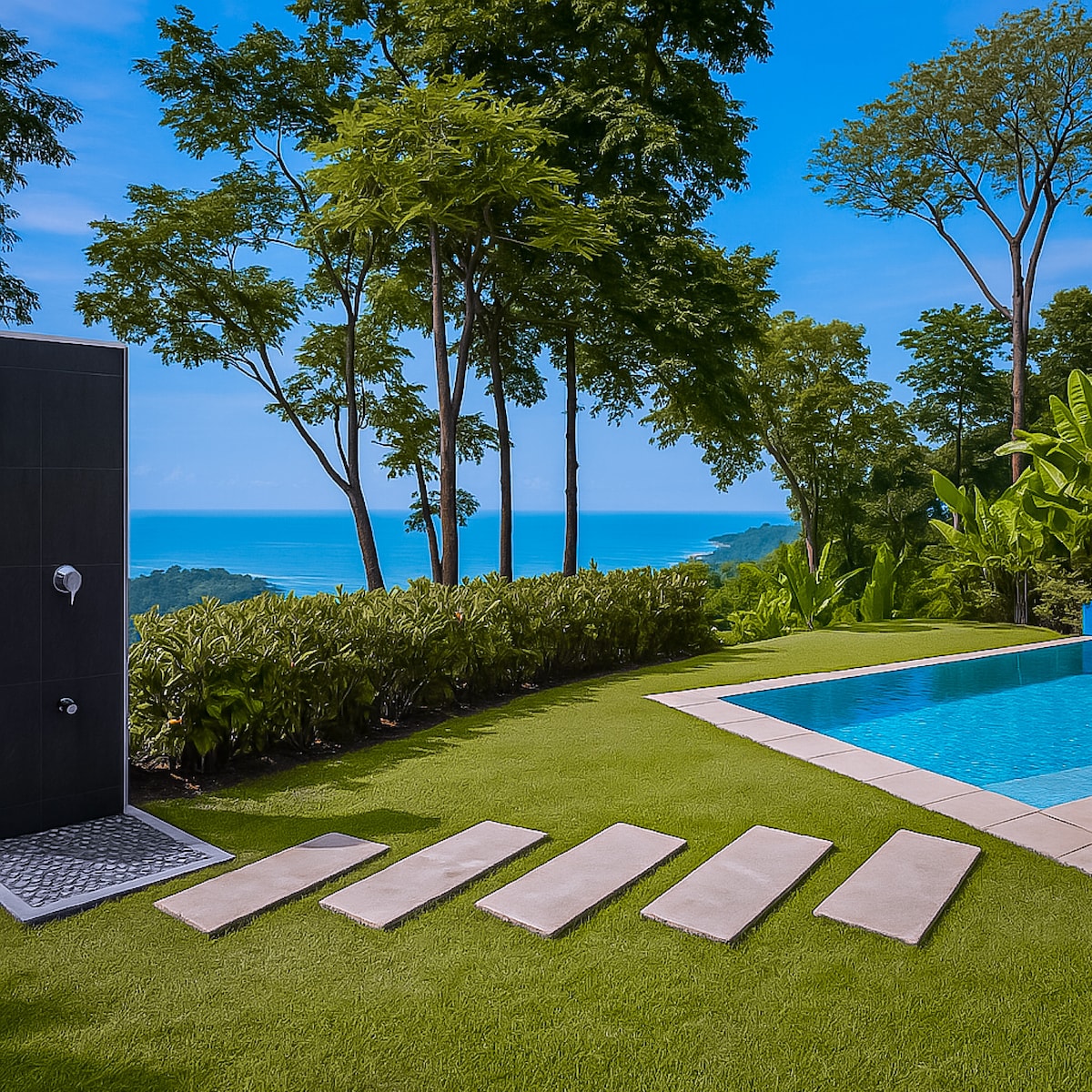 An infinity pool extends toward the horizon, framed by lush greenery and tropical trees. Stone stepping pads lead from the outdoor shower to the pool area, with expansive ocean views visible in the background under a clear blue sky.
