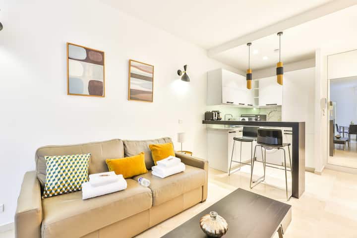 אזור מגורים נוח ומואר עם ספה נפתחת לשניים, טלוויזיה ומטבח מאובזר