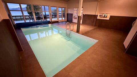 Indoor pool and beach by the fjord