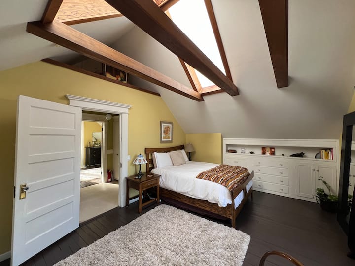 أول غرفة نوم واسعة مضاءة بشكل جميل بواسطة مصباحين سماء على سقف الإطار على شكل حرف A.  يحتوي على سرير بحجم كوين مع ملاءات قطنية مصرية 100% وغطاء لحاف. 