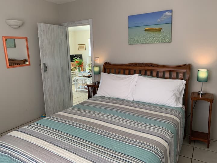 Queen bedroom with en-suite which has a large walk-in shower, toilet and basin.