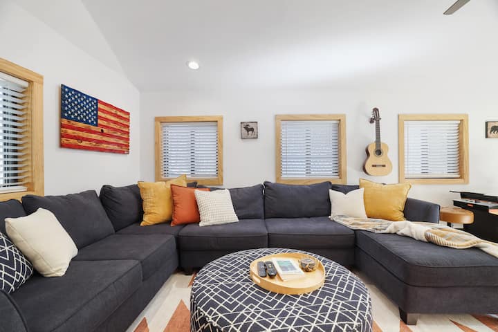 Spacious family room with Smart TV, convertible sectional with full-size sleeper, open layout, and indoor games. Perfect for relaxing after a day outdoors.