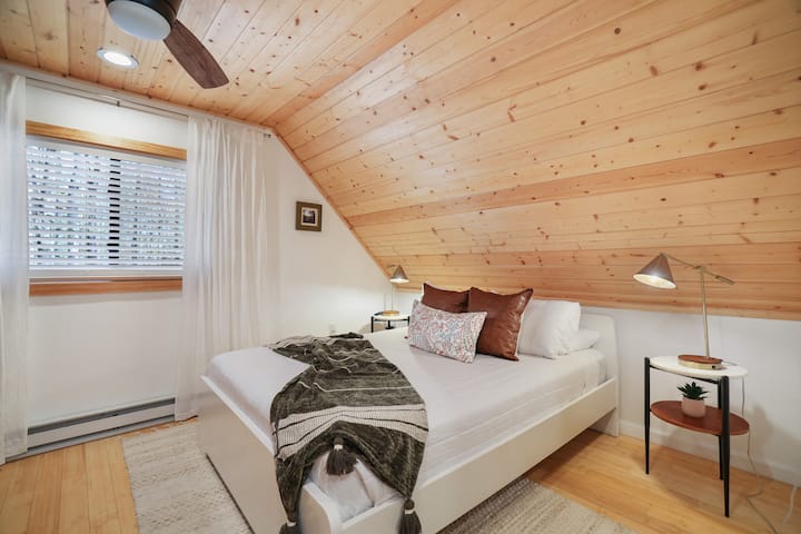 The primary bedroom, located on the second floor, features a private ensuite half bath.