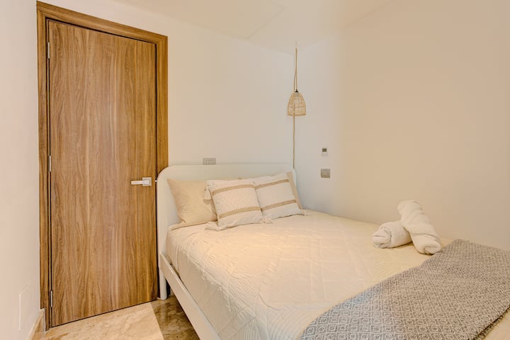Luxury bedroom with a premium bed, private bathroom, and elegant finishes for a peaceful stay in La Amada, Playa Mujeres.