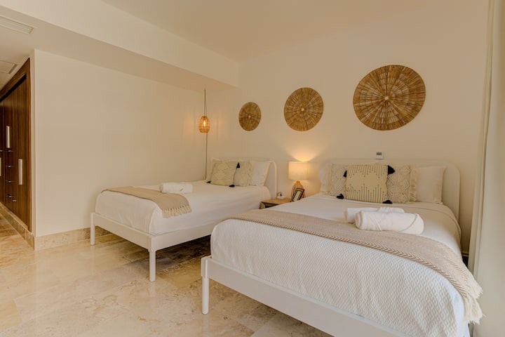 Luxury bedroom with a premium bed, private bathroom, and elegant finishes for a peaceful stay in La Amada, Playa Mujeres.