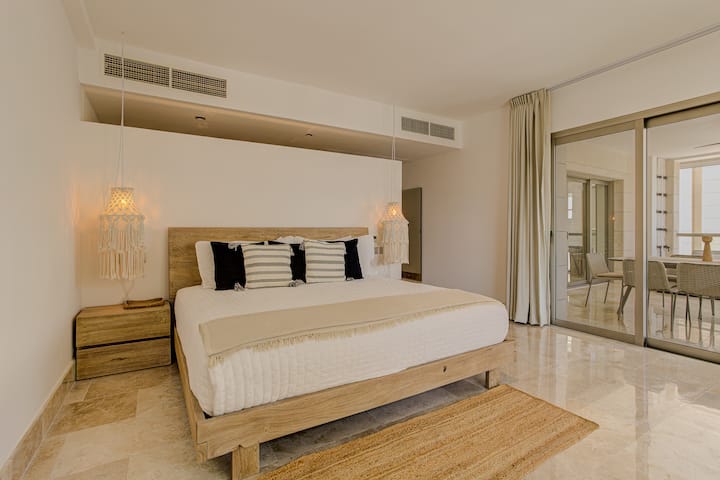 Luxury bedroom with a premium bed, private bathroom, and elegant finishes for a peaceful stay in La Amada, Playa Mujeres.