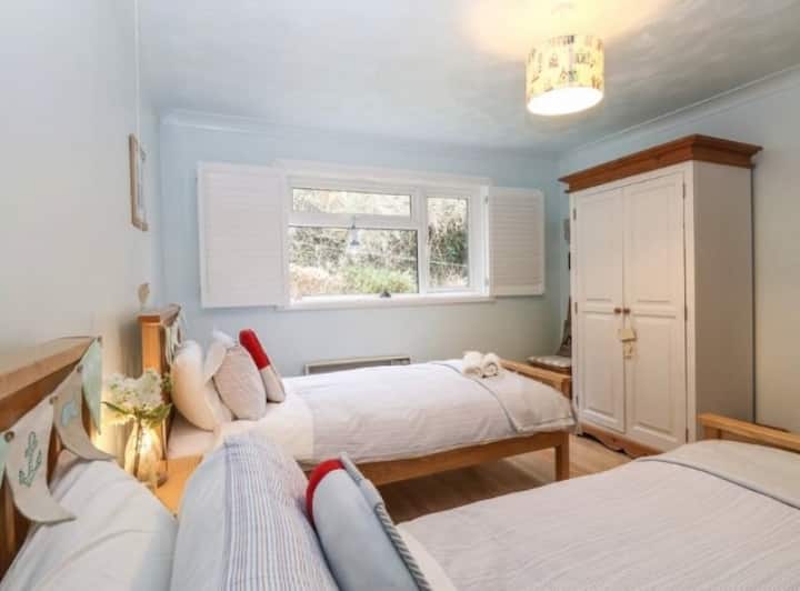Rear bedroom with 2 single beds  ,wardrobe and chest of drawers. Window to rear garden 