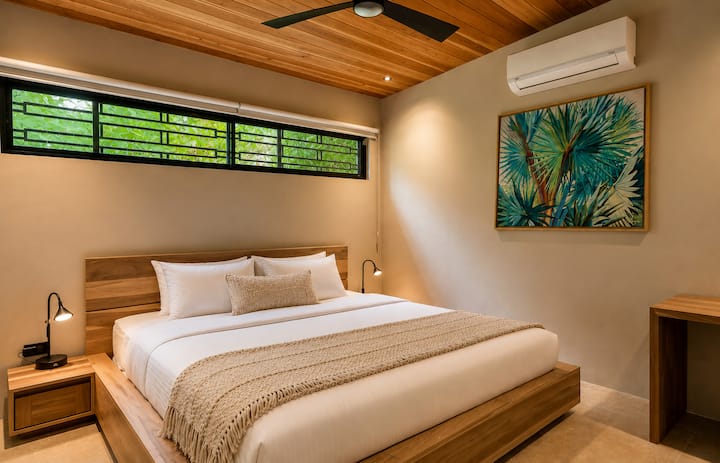 Isang maliwanag at kaakit‑akit na VIP na king bedroom na may mga premium na linen na katulad ng sa hotel, mga handcrafted na muwebles na gawa sa kahoy, orihinal na tropikal na likhang‑sining, at isang tahimik na kapaligiran na idinisenyo para sa malalim at nakakapagpahingang tulog sa gitna ng Costa Rica.