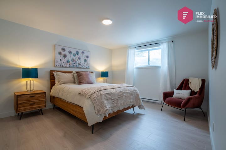 Comfortable bedroom #3 in the basement with a queen-size bed and en-suite bathroom