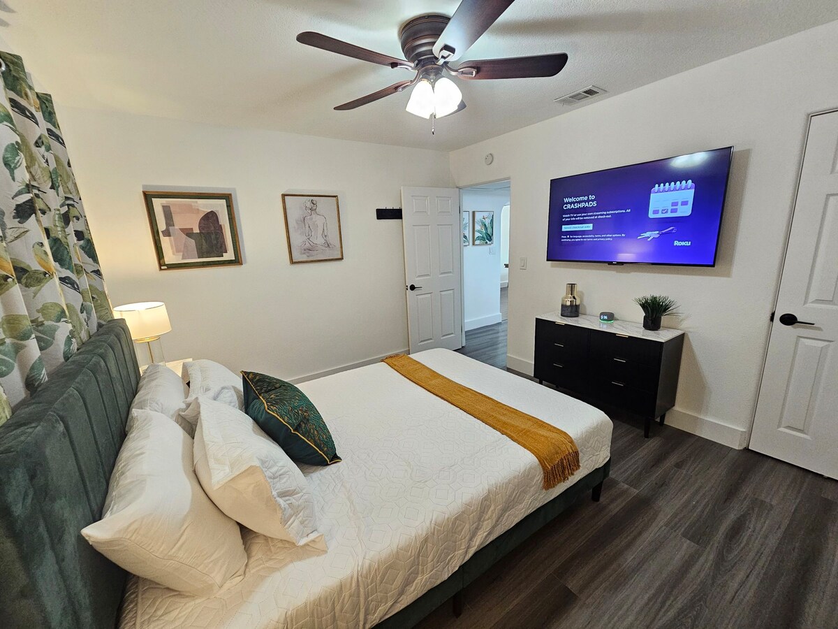 Primary Suite #1 in front of home with Roku TV, closet space and black out shades, fan