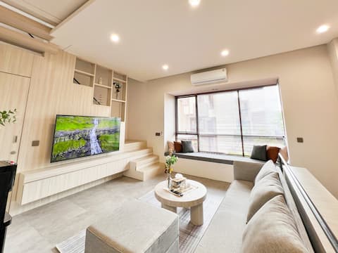 Cozy living room with a large TV near ICE BSD