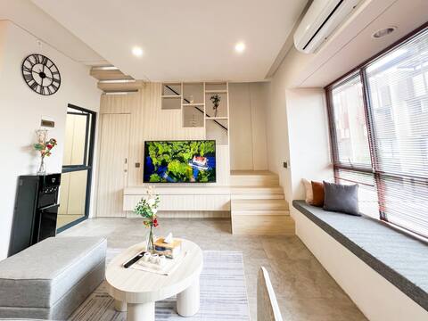 Cozy living room with a large TV near ICE BSD