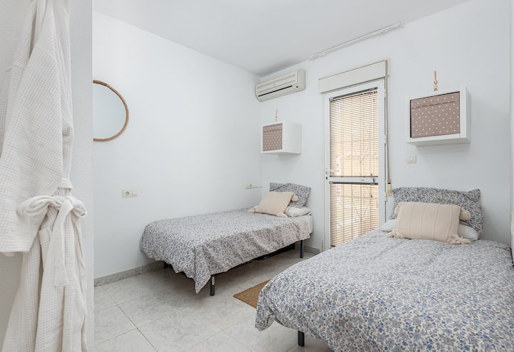 2 single beds, storage cubes, as well as a double built in wardrobe. Direct access to back terrace.