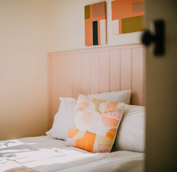 Drift off in this cozy, feel-good bedroom with soft colors, fluffy pillows, and crisp sheets you’ll never want to leave. Wake up slow, stretch out, and soak in the calm vibes. It’s the kind of comfy spot that makes hitting snooze totally worth it.