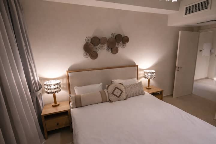 Spacious bedroom with large windows that fill the room with natural light. Features built-in closets for ample storage. A serene space designed for restful nights.
