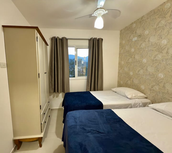 Cozy room with two single beds and bed linen available, ideal for friends or children. Rest in comfort and privacy.