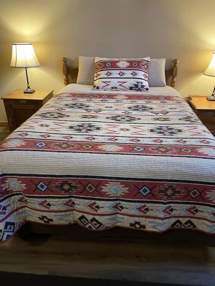 Comfortable king bed in master bedroom complete with dresser and smart tv 