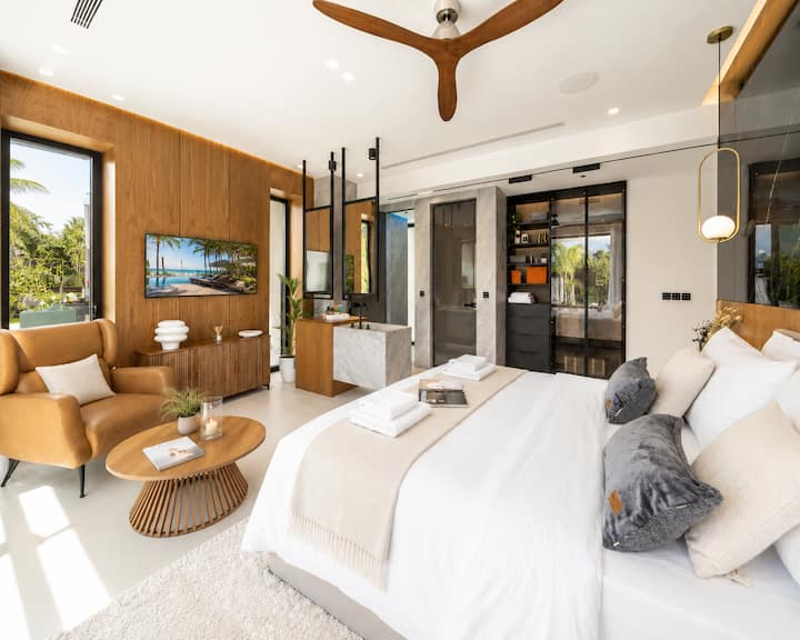 Ground Floor - Bedroom 1 with queen bed, ensuite bathroom, Grohe hydromassage shower, and direct pool access.