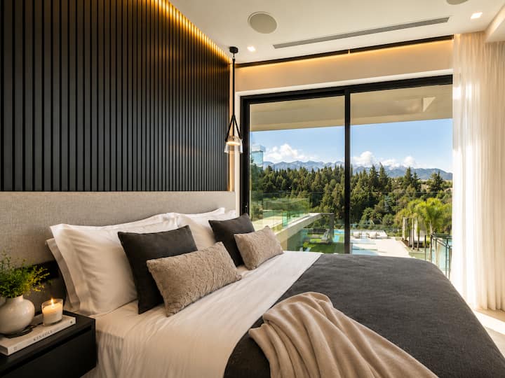 Bedroom 3 - Wake up to beautiful views across the private pool, lush cypress forest and Cretan landscape from this intimate, elegantly designed bedroom.