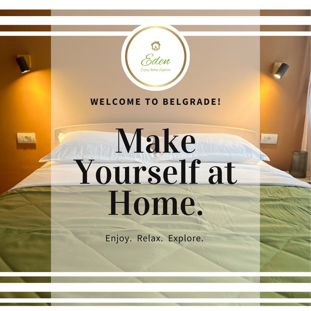 A spacious bedroom is presented with a large bed covered in a light green comforter. Soft lighting from the wall sconces highlights the neutral colors of the room, creating a calm environment. Welcome text is featured prominently, inviting guests to feel at home.