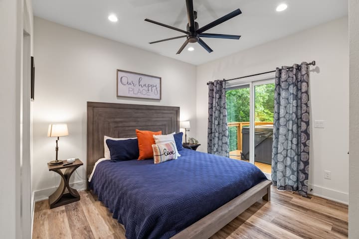 Bright bedroom with quality linens and blackout-ready shades.