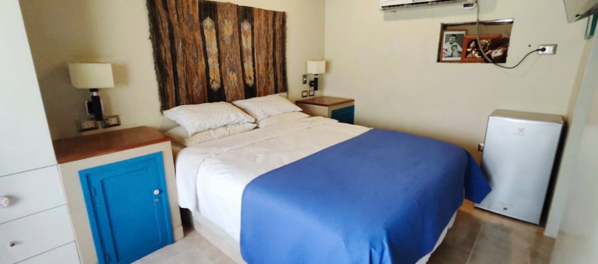 Main room on second floor, has air conditioning, fridge bar, private bathroom, roperos and smart TV. 