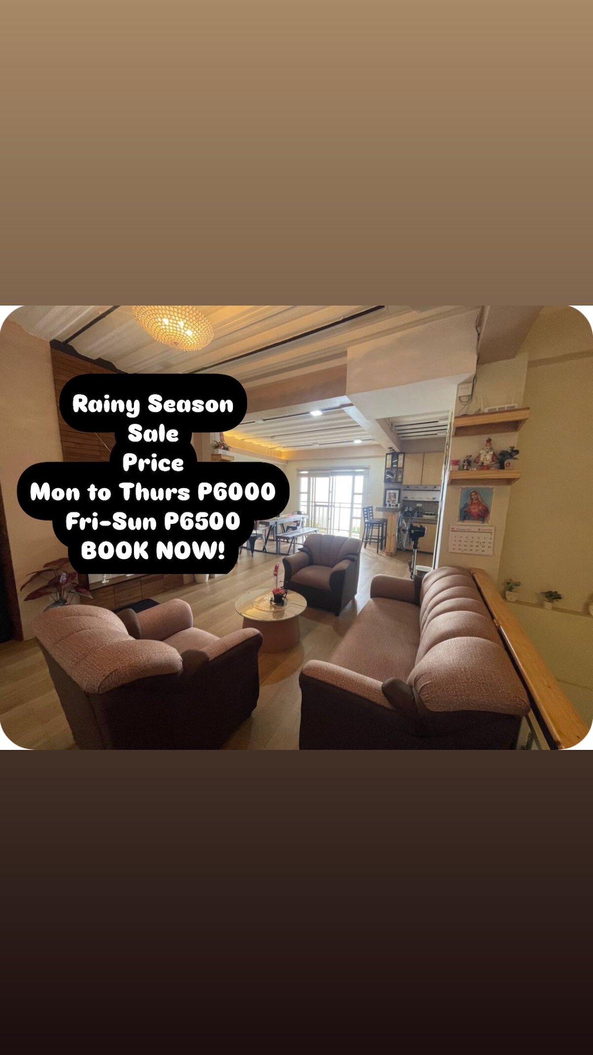 A cozy living area is presented, featuring a circular arrangement of plush seating. A coffee table is centered, and natural light filters through large windows, illuminating the space. Decor includes framed photographs and wall art, enhancing the inviting atmosphere.