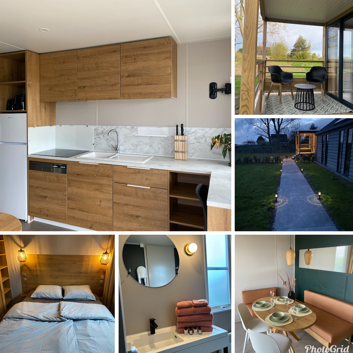 A modern kitchen features wooden cabinetry, a marble countertop, and essential appliances, including a refrigerator and dishwasher. The living area has a cozy dining table paired with orange upholstered chairs. A well-lit sleeping area showcases neatly arranged bed linens and wall-mounted shelving for storage.