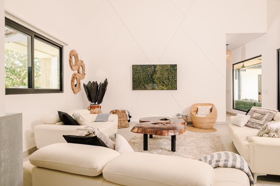 The living room, white and open, with garden windows