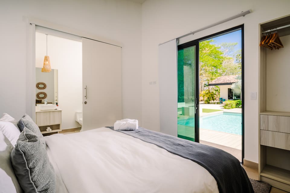 A bedroom with sliding doors to the pool