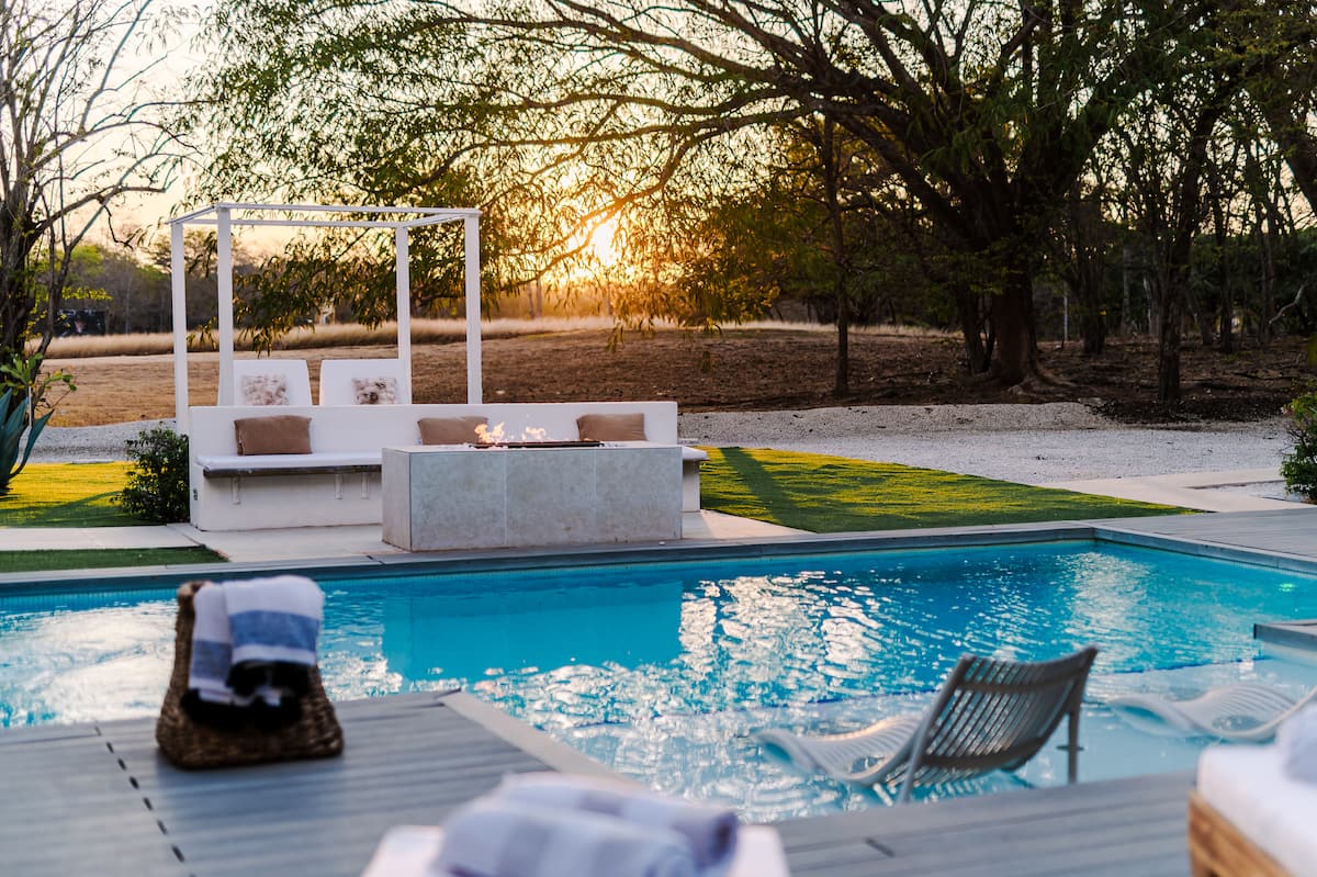 In-water loungers in the pool at sunset