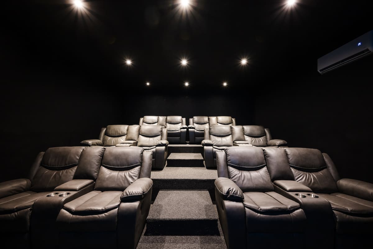 The private cinema: rows of recliners under a ceiling of small lights