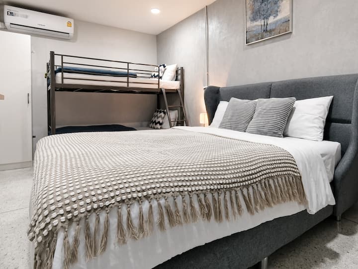 Bedroom 2 (2nd Floor):— Features a queen bed, a bunk bed, and a makeup table.