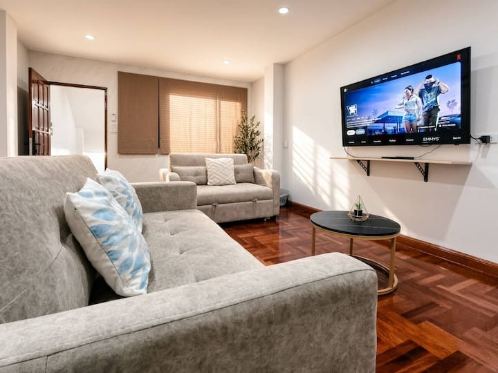 Living Room 2 The comfy sofa beds can sleep up to 3 guests. Enjoy a relaxing night with the 65” smart TV, complete with cable channels