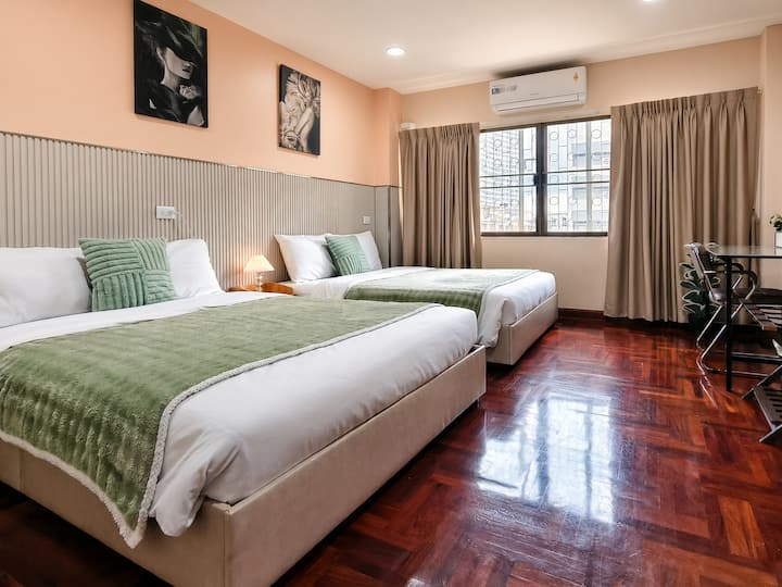 Bedroom 5 (4th Floor) — A bright and roomy space featuring two queen beds comes with a wardrobe and a makeup table, comfortable and practical ideal for sharing.