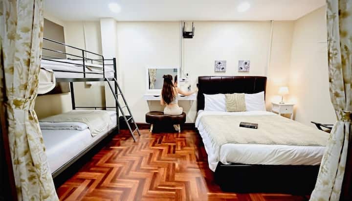 Bedroom 6 — A cozy and functional room featuring a queen-size bed and bunk beds. Includes a makeup table.