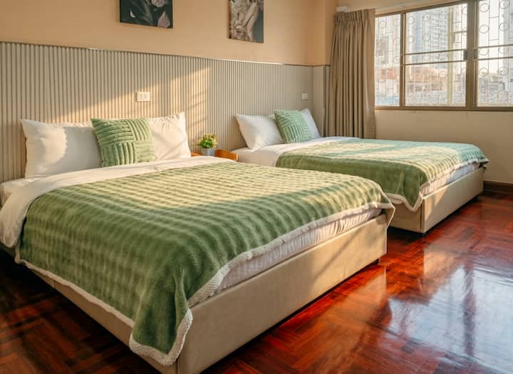 Bedroom 5 (4th Floor) — A bright and roomy space featuring two queen beds comes with a wardrobe and a makeup table, comfortable and practical ideal for sharing.