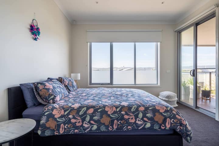 The primary bedroom boasts direct balcony access and comes with a walk-in wardrobe and ensuite bathroom.