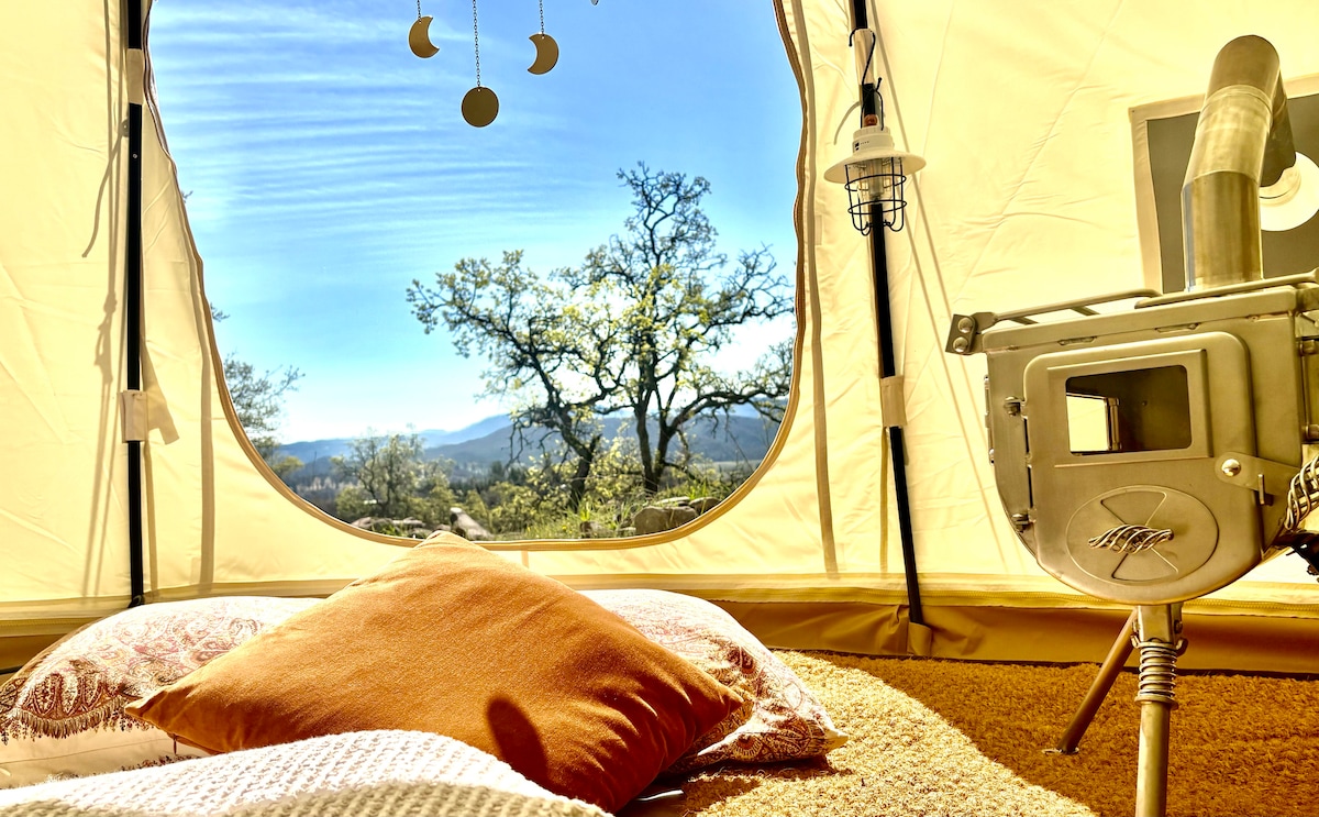 The Astral has a real Winnerwell wood burning stove (Winter only) and Pottery Barn floor cushions, canvas butterfly chairs, a custom Life in Tents coconut coir carpet, and views...