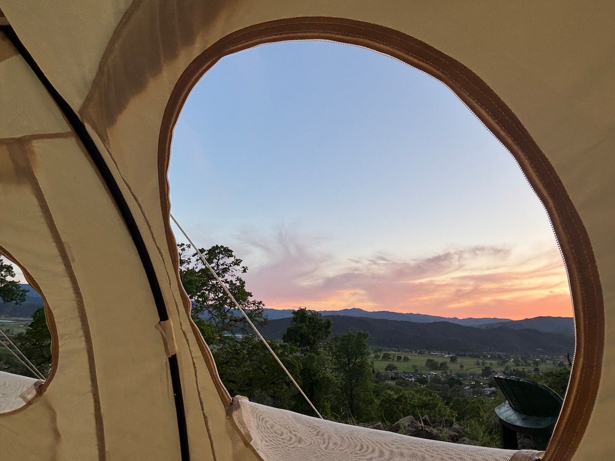 The luxury Astral lotus dome tent has four porthole windows that are positioned to take in the mountain views and provide cross ventilation and breezes from the Pacific Ocean beyon