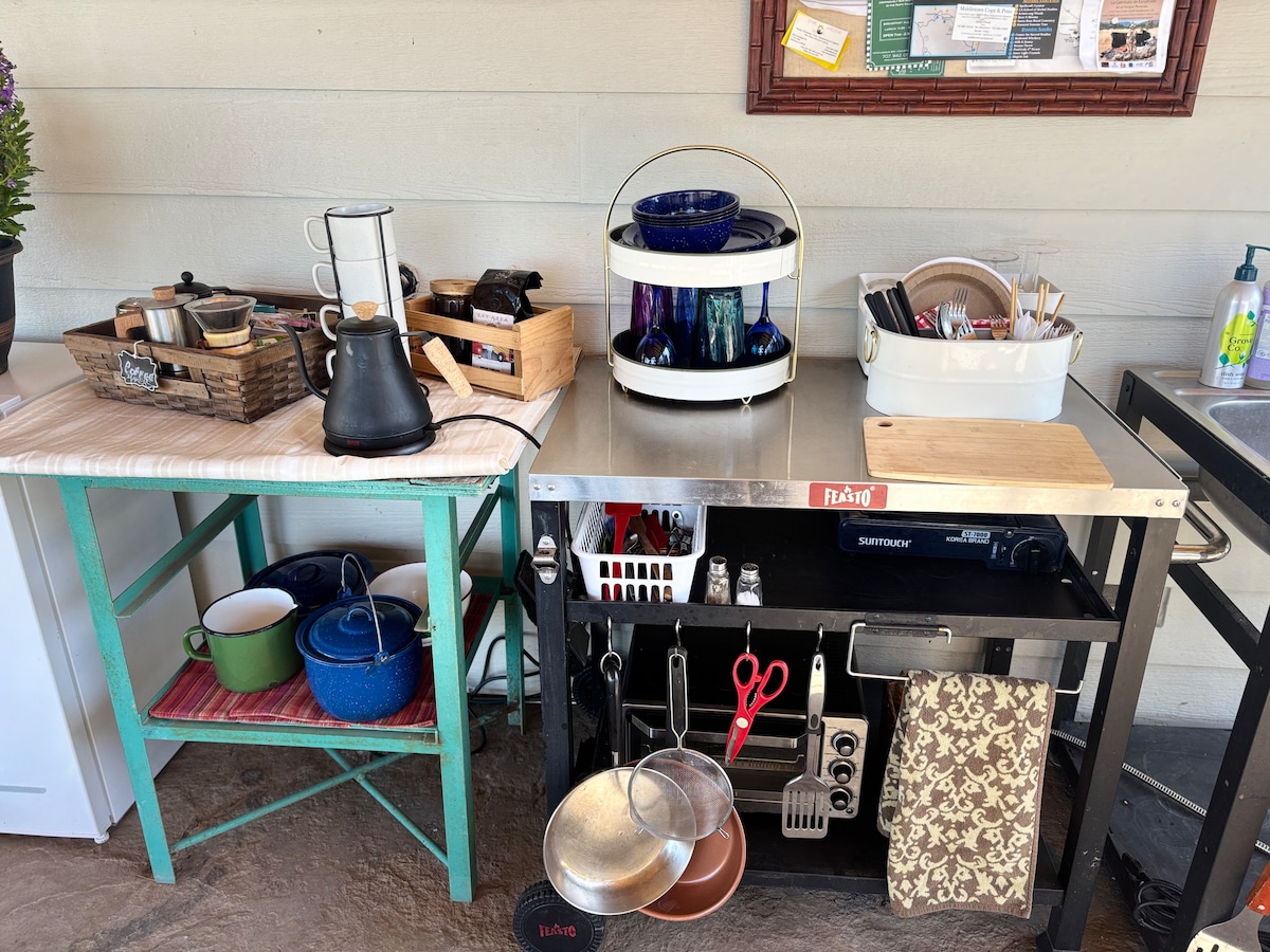 Shared outdoor kitchen area with coffee bar, fridge, dish sink. at Stargazing Dome in Hidden Valley Lake