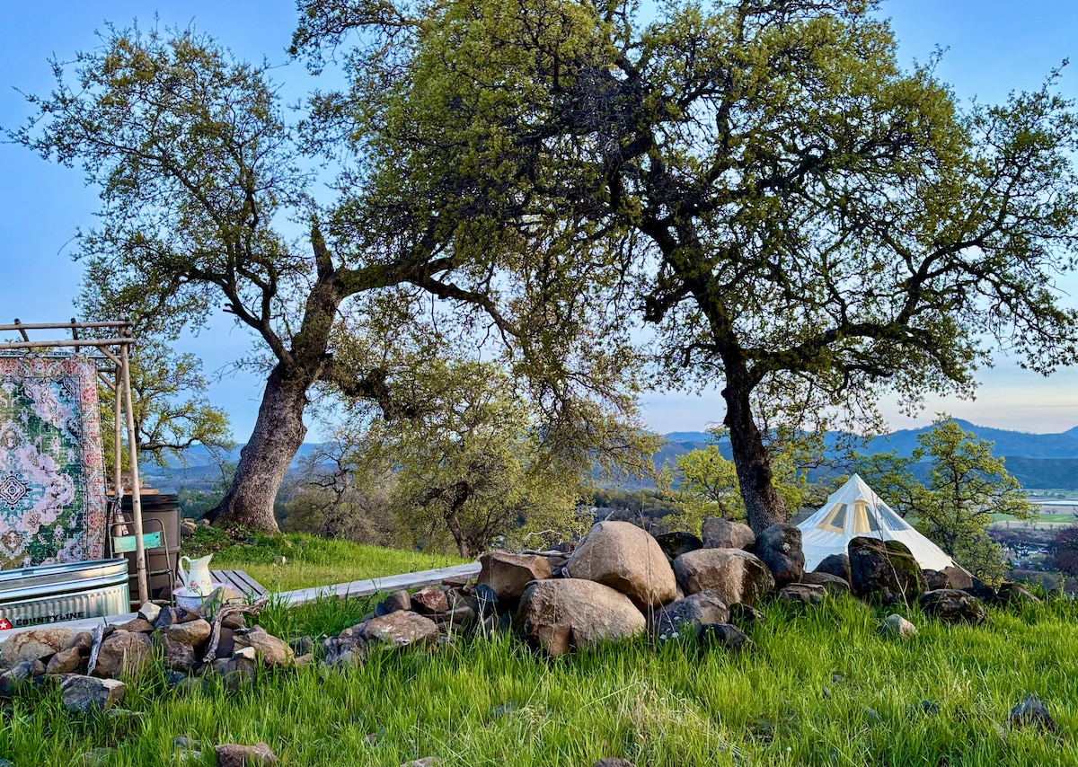 Cowboy style hot outoor bath with boho style bamboo enclosure and privacy curtains, forever views. at Stargazing Dome in Hidden Valley Lake