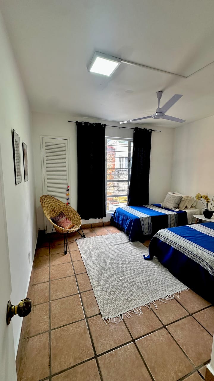 Bedroom 2 with 2 single beds, ceiling fan and large closet.