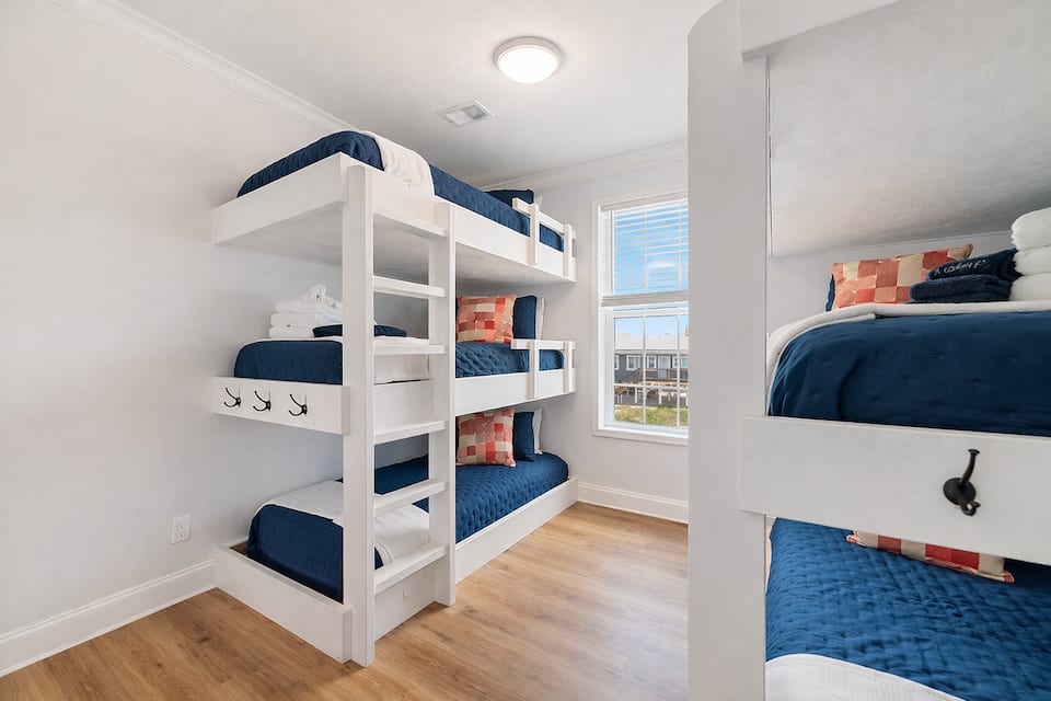 Bunk room with two custom triple twin bunks