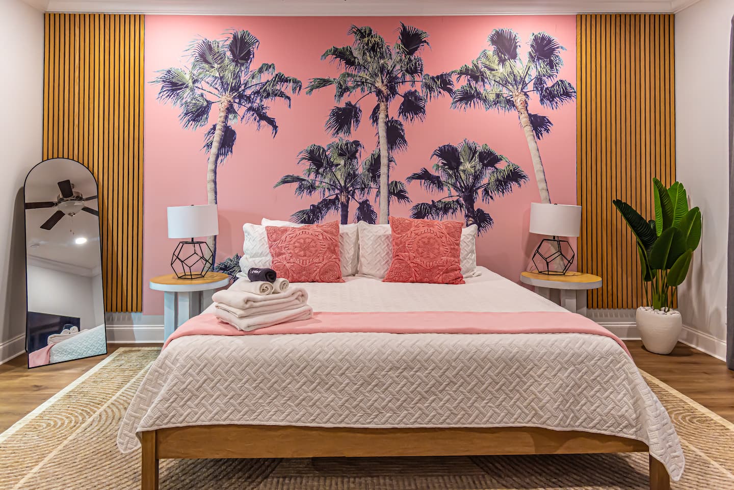 Primary suite with king bed and palm mural