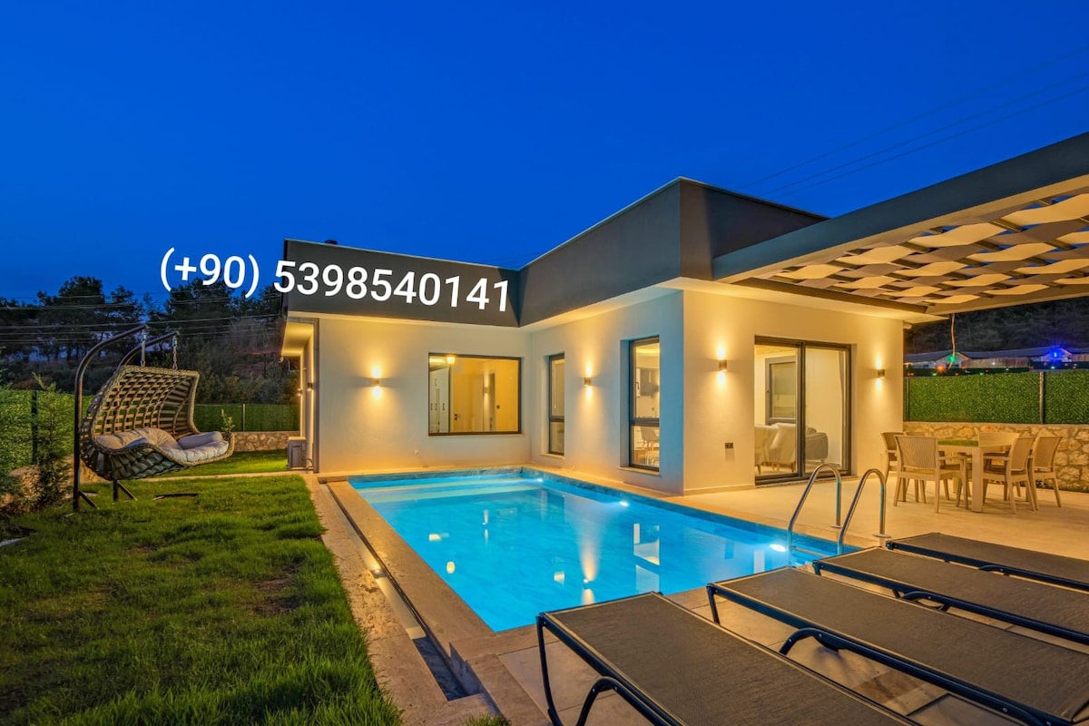 An outdoor area features a well-maintained swimming pool, surrounded by comfortable lounge chairs. A dining set is visible on the patio, along with a cozy swing chair. Large glass doors lead to a bright interior space, creating a seamless connection between indoor and outdoor living.