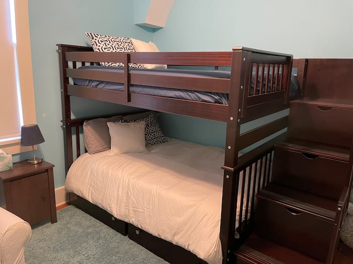 Dhomë gjumi me përmasa të mëdha me krevat marinari (me shkallë deri në krevatin e sipërm), dyshekë Tempur-pedic, komodinë me abazhur, karrige lëkundëse Pottery Barn, komo të lartë, dollap, lodra fëmijësh, lojëra dhe libra.