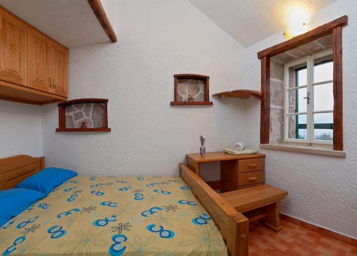 The second bedroom located in a separate guest house for maximum privacy. It features a comfortable Queen-size bed (160x200 cm) for two and its own private, full bathroom with a shower. Perfect for a peaceful stay.