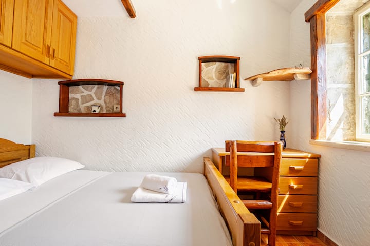 The bedroom is located in a separate guest house for maximum privacy. It features a comfortable Queen-size bed (160x200 cm) for two, plus its own private full bathroom with a shower. Perfect for a peaceful stay.