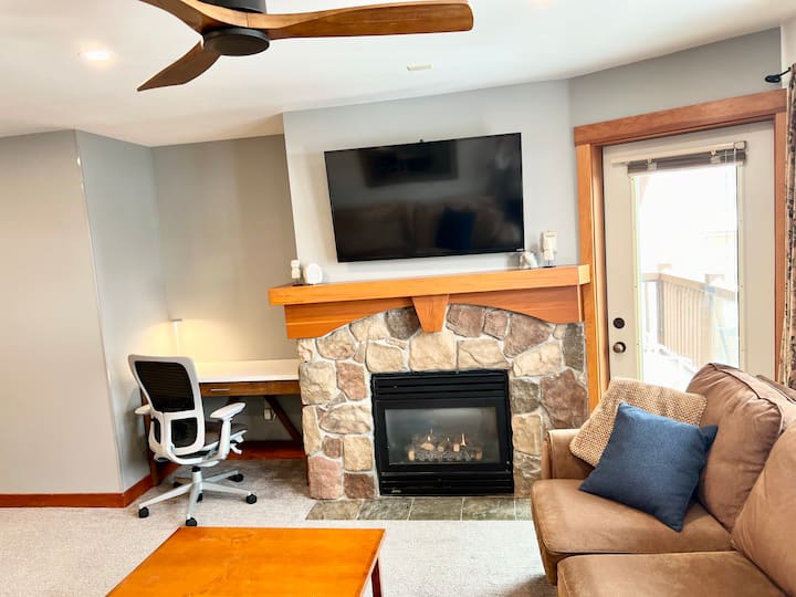 Ski slope view from sofa and deck!! 

Workspace is within Living room; complete with adjustable ergonomic Haworth brand task chair, LED Pablo brand task light, and desktop USB power.  

Direct TV included; 2 large flat screen TV's in condo.